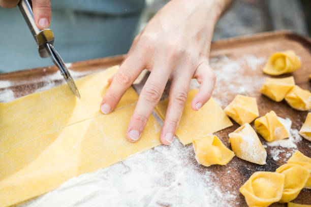 istock chef preparing handmade stuffed pasta tortellini 639925546
