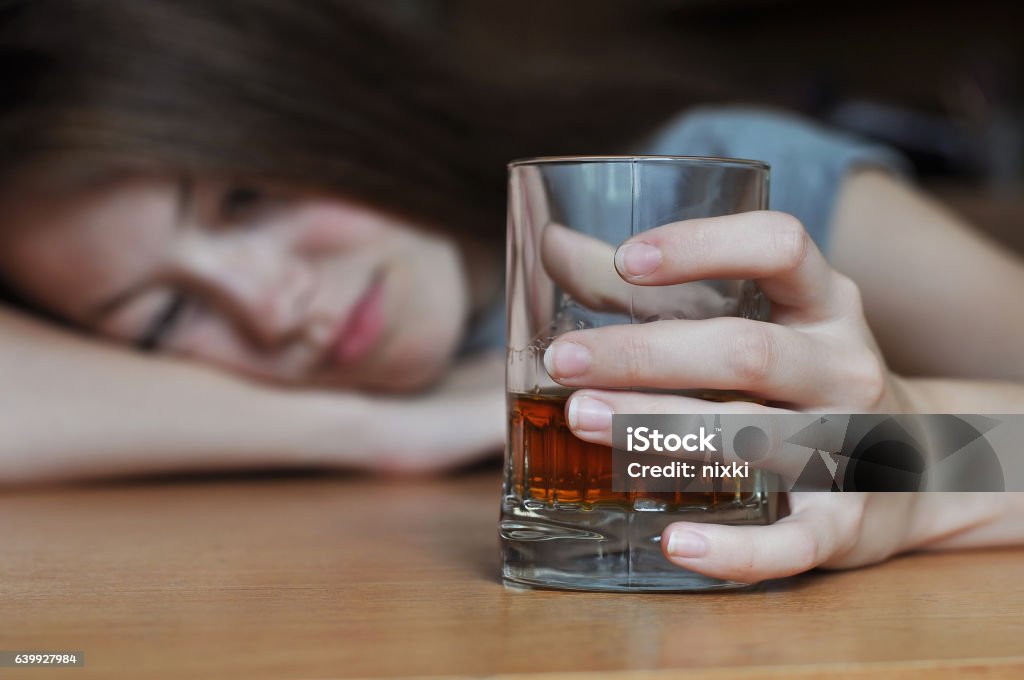 Drunk female addict Drunk female with a glass of whiskey Alcohol - Drink Stock Photo