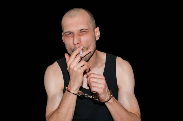 istock Prisoner in handcuffs smoking his last cigarette. 639930186