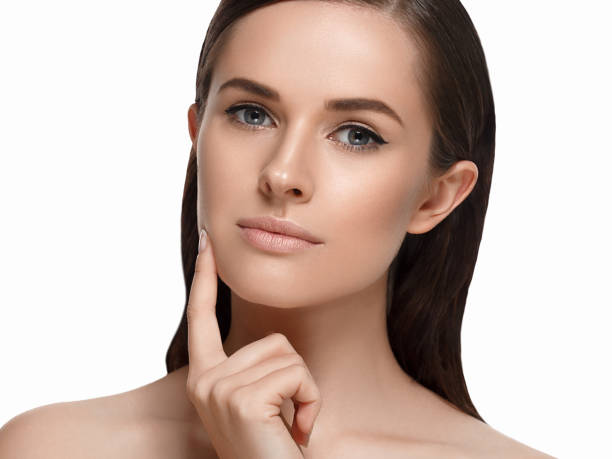 istock Young beautiful woman face portrait  touching her face. Studio shot. 639931984