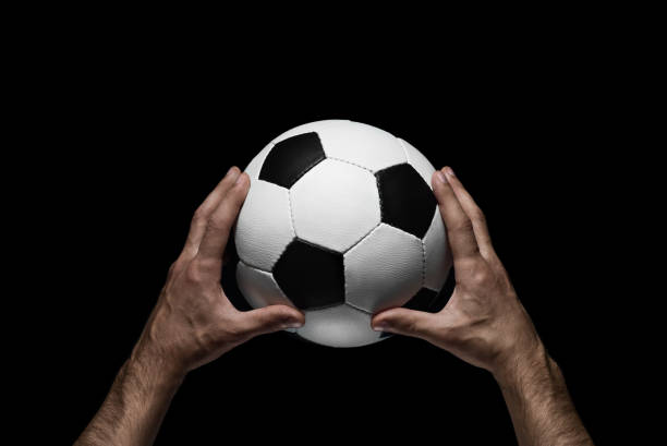 istock soccer ball in male hands 639932636