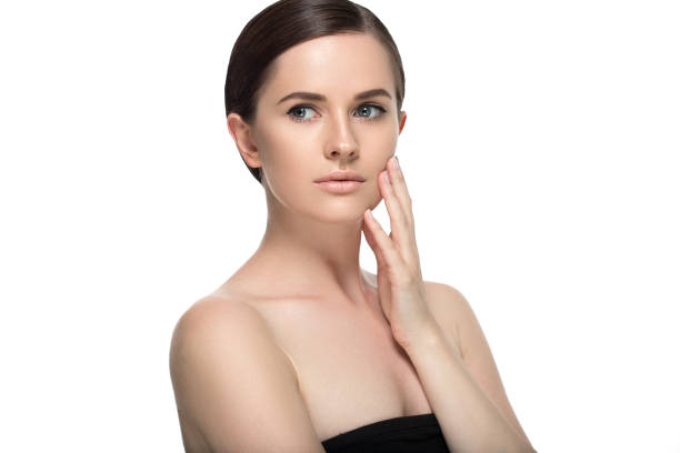 istock Young beautiful woman face portrait  touching her face. Studio shot. 639932676