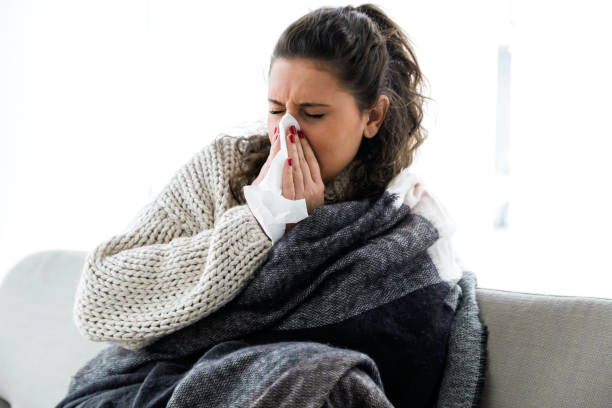 istock Illness young woman sneezing in a tissue. 639934926