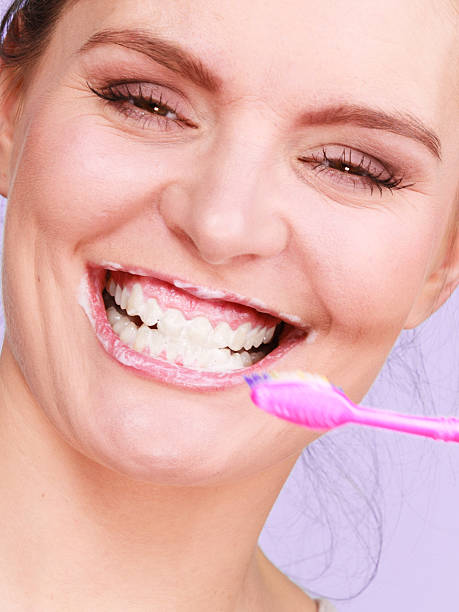 istock Woman brushing cleaning teeth 639936168
