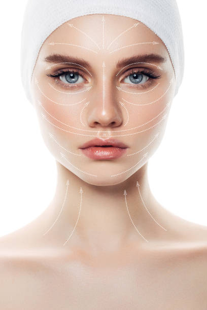 Woman's face with arrows as a model of facial massage Woman's face with arrows as a model of facial massage face mask beauty product stock pictures, royalty-free photos & images