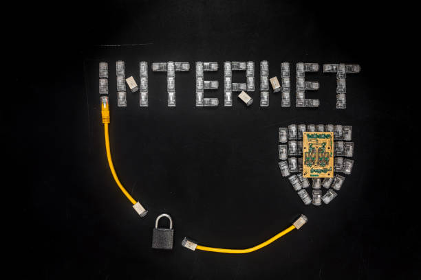 Word "Internet", shield made of connectors RJ45 and padlock Word "Internet", shield made of connectors RJ45 and padlock.  Yellow patch cords composition isolated over the black scratched board background. Concept of internet security/computer data encryption / data protection / security enhancement / internet communication. computer plan fiber optic engineer stock pictures, royalty-free photos & images