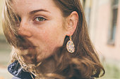 Beautiful woman face portrait freckles street city fashion