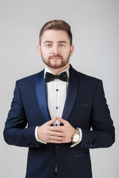istock Handsome man in tuxedo and bow tie looking at camera 639939864