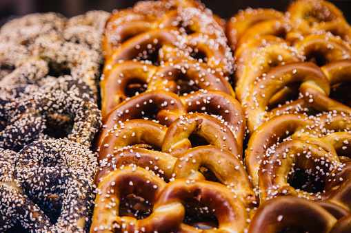 Assortment of Traditional Alsatian and Bavarian Bretzels with sea salt, sesame and sugars. Pastry of German bread, Pretzels, Bretzel, Brezl, Breze