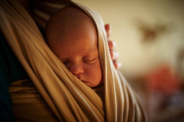 infant in sling baby in sling baby carrier stock pictures, royalty-free photos & images