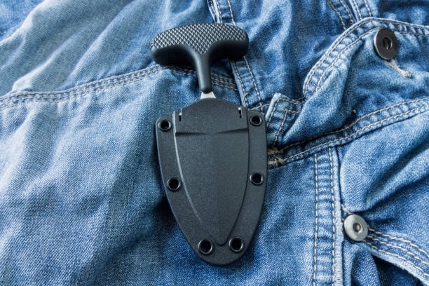 istock Urban knife in case on jeans background. The vertical position. 639945374