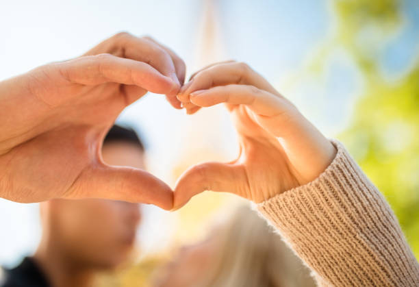 istock woman doing an heart shape in Paris 639946578