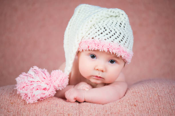 istock Newborn baby in a warm knitted hat. 639948070