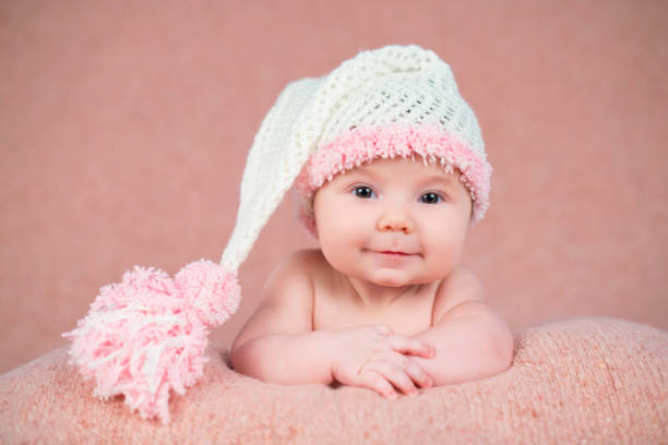 istock Newborn baby in a warm knitted hat. 639948144