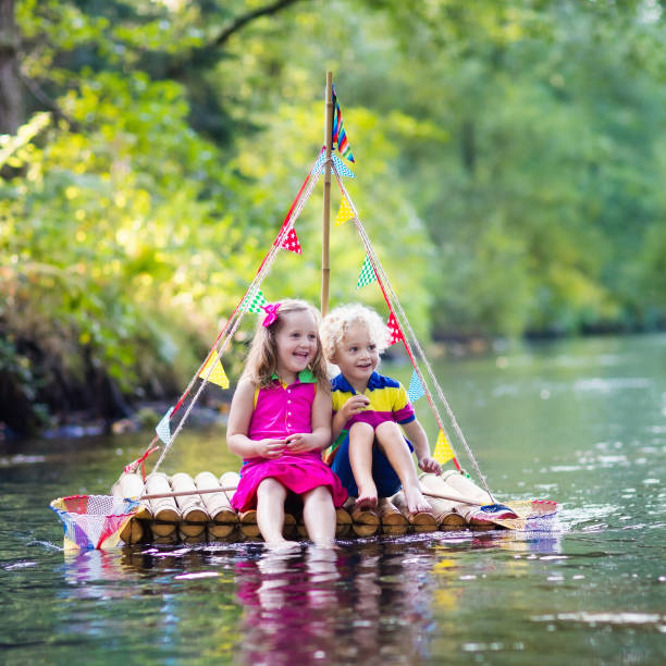 istock Two children on wooden raft 639950266