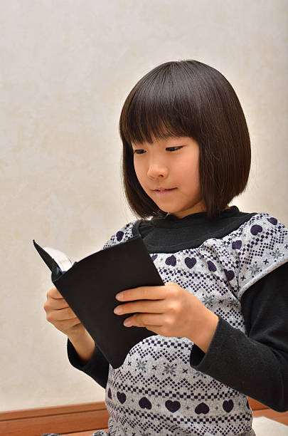 istock Japanese girl reading a book 639951940