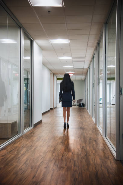 istock One Confident Businesswoman Walking Alone Through the Office 639952120