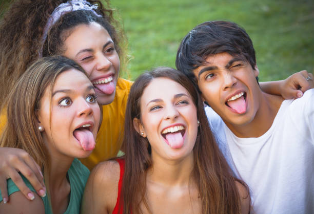 istock Group of happy teenagers in the park 639952182