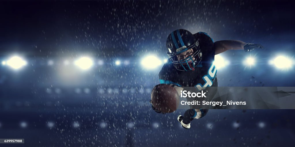 American football player . Mixed media Confident American football player in lights of sport arena. Mixed media Three Dimensional Stock Photo