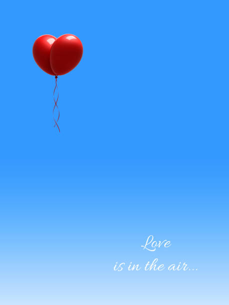istock Red Balloons Forming a Heart Shape on Blue Sky 639961956