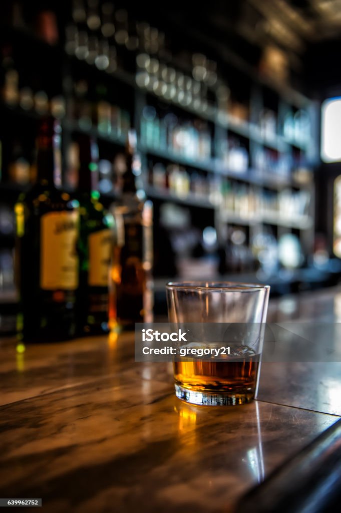 Irish Whiskey Image of a glass of whiskey on a bar with blurred background Whiskey Stock Photo