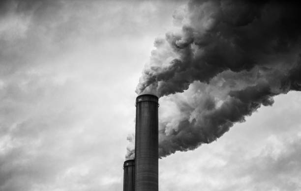 Black and White of smoking smokestacks stock photo