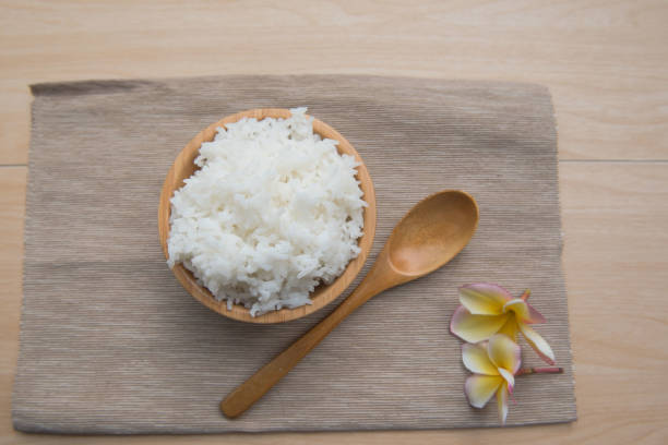 istock Cooked rice in a wooden bowl and spoon 639963110
