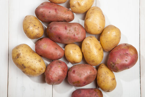 istock Potatoes on a white wooden background 639963532