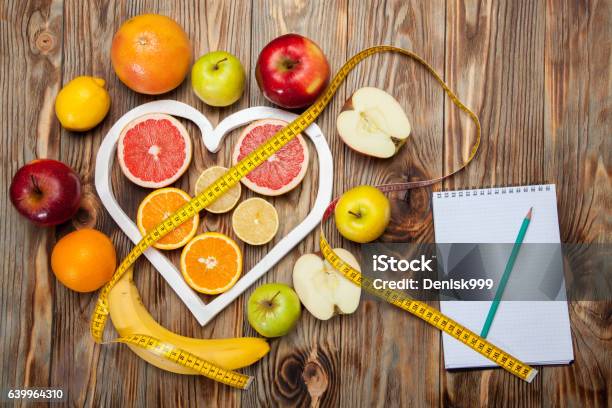 Fruit Diet Centimeter And Plan On A Wooden Background Stock Photo - Download Image Now