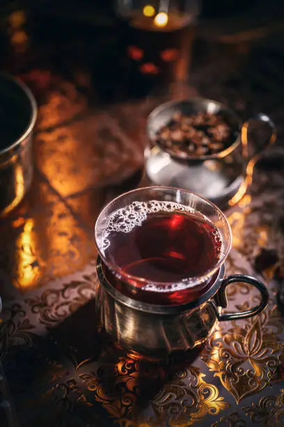 Black tea in a glass cup on dark background