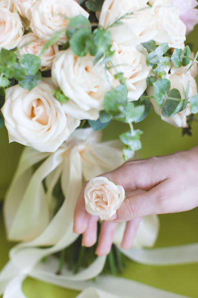 istock Modern beautiful wedding bouquet of roses and hand 639965656