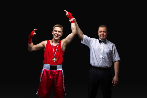 istock Boxing referee gives medal to young boxer 639967512