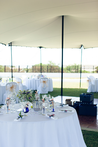 Decorated wedding table under a tent on a park