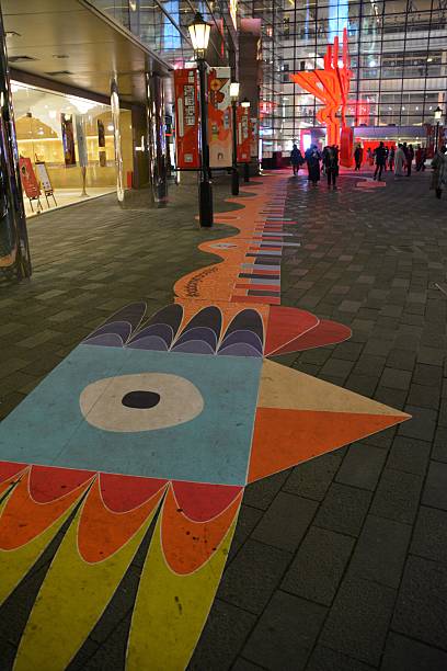 Shanghai, China - January 28, 2017: People in the background, walking in Xintiandi, looking an artistic representation celebrating the 2017 Chinese New Year, the year of the rooster. Xintiandi is a landmark entertainment area in the heart of downtown Shanghai, with many restaurants, upscale bars, and boutiques. 