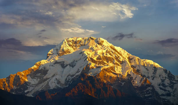istock Mountain peak in the rays of the rising sun 639970466