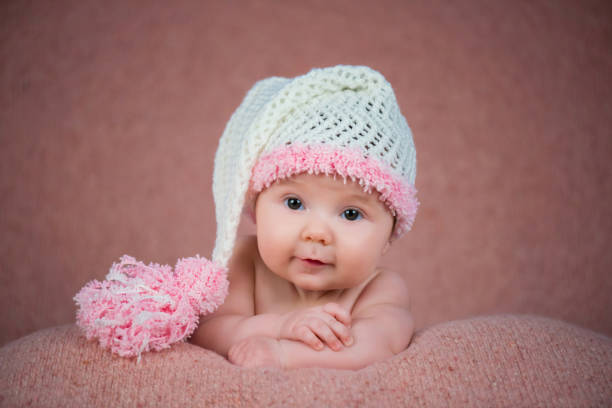 istock Newborn baby in a warm knitted hat. 639972998