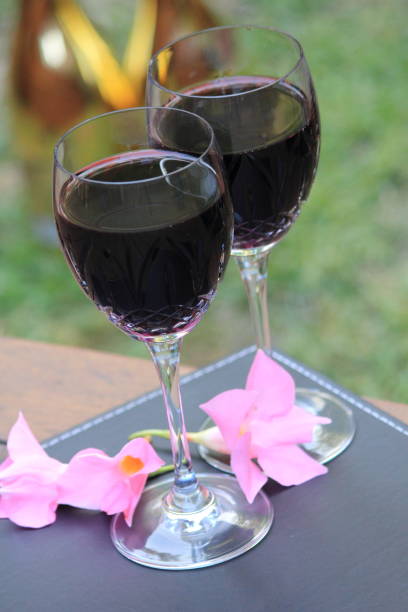 istock two glasses of red wine on the wooden deck 639977152
