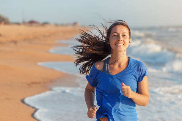 istock Fitness woman running on the beach 639977272