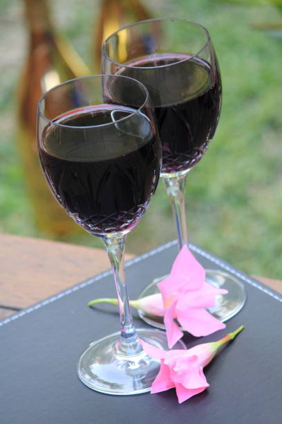 istock two glasses of red wine on the wooden deck 639977352