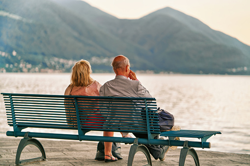 Ascona, Switzerlnd - August 23, 2016: Senior Couple sitting on the bench at the embankment in Ascona on Lake Maggiore, Ticino canton of Swiss