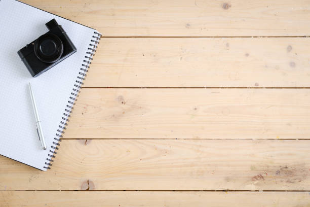 Wooden desk with various gadgets and accessories, top view