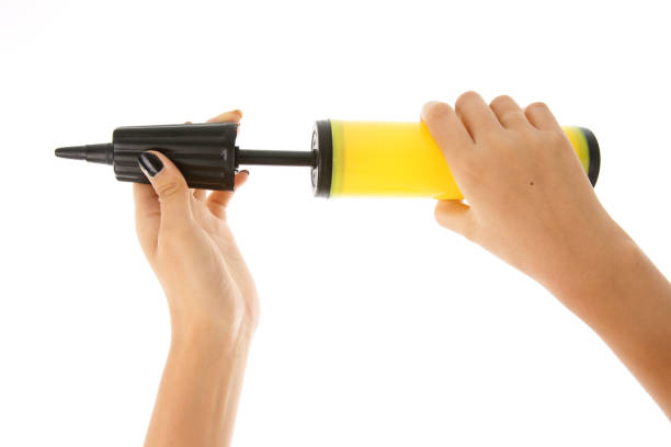 istock Woman's hand holding an air pump on white background 639979542