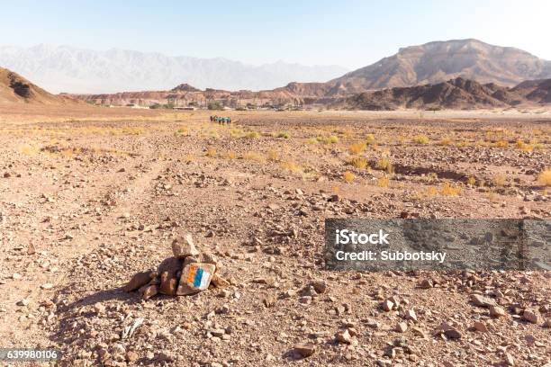 Trail Marking Stone Sign Group People Hiking Backpackers Traveli Stock Photo - Download Image Now