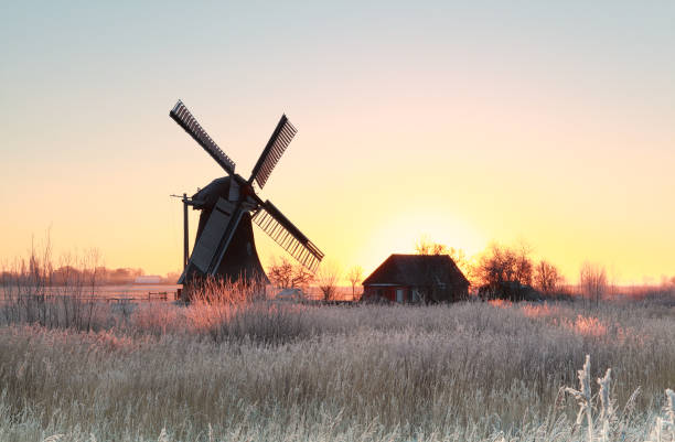 istock sunrise over frosted meadow and windmill 639980538