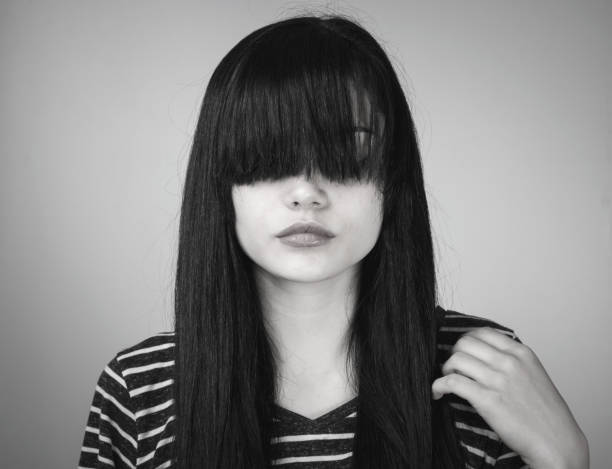 istock Sad young girl hides her face with bangs 639982894