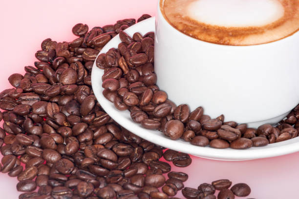 Black coffee beans with milk mug, white color cup and background, colorized photograph including perfect lights, very tasty hot drink of luxury house.