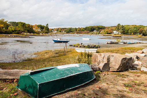 Boats aground at low tide with Autumn color near York Maine