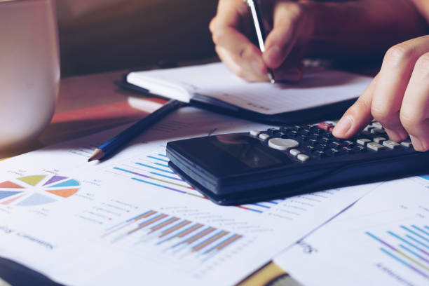 istock Woman calculate about expenses and making note on table 639992628