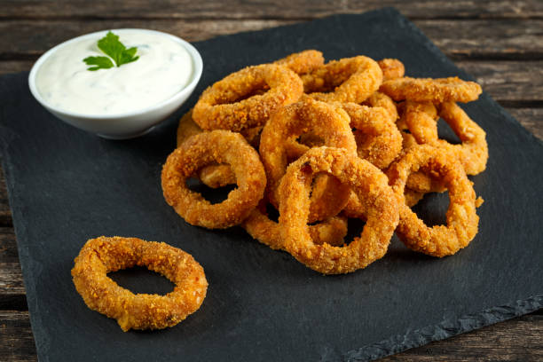 istock Fried Breaded Onion Rings with sauce on stone board 639992658