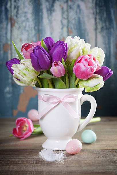 istock Beautiful tulips bouquet and easter eggs  on wooden table 639997092